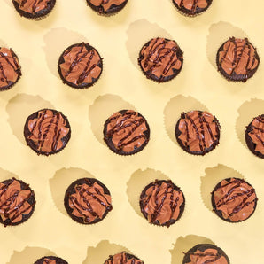 Vegan Chocolate Cupcakes topped with plant-based buttercream and chocolate drizzle, freshly baked by Crumbs & Doilies.